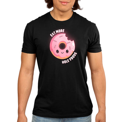 Premium Cotton T-shirt_TeeTurtle black Eat More Hole Foods apparel featuring a smiling pink sprinkle donut with a bite taken out of it. Caption reads, "eat more hole foods".