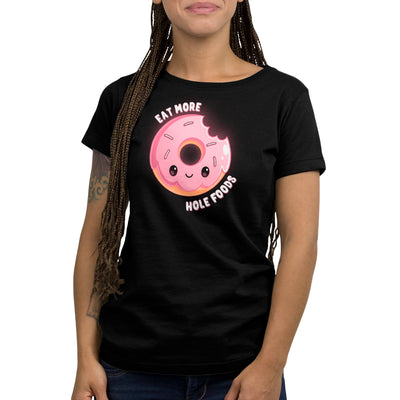 Premium Cotton T-shirt_TeeTurtle black Eat More Hole Foods apparel featuring a smiling pink sprinkle donut with a bite taken out of it. Caption reads, "eat more hole foods".