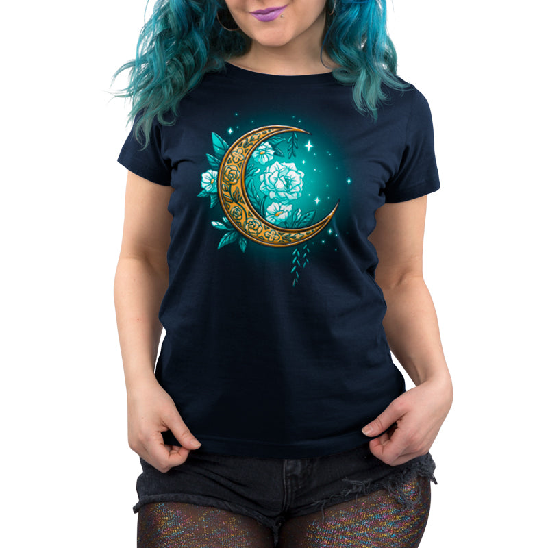 A woman with blue hair wearing a Floral Moon T-shirt by TeeTurtle featuring a crescent moon.