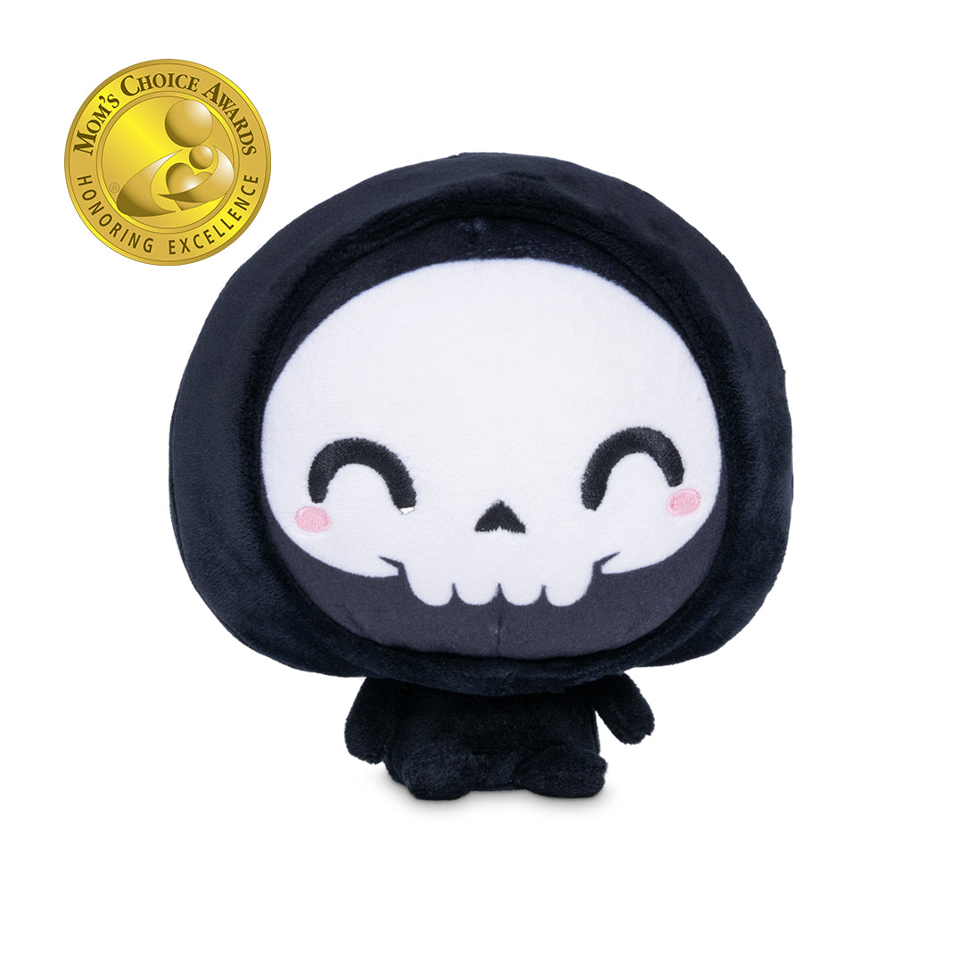 Cloudheads: 5" Grim Reaper (Grim) - A black hooded plush grim reaper with a white skull face, black embroidered eyes and mouth, and small pink cheeks, shown on a plain white background. A gold Mom's Choice Awards badge appears in the top-left corner.