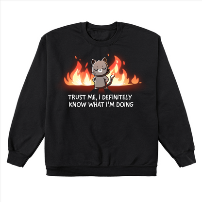 Crew Neck Sweatshirt_TeeTurtle black I Definitely Know What I'm Doing Crew Neck Sweatshirt featuring a smug gray cat standing confidently in front of bright flames with the text "Trust Me, I Definitely Know What I'm Doing."