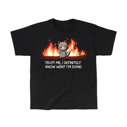 Kids' Classic T-Shirt_TeeTurtle black I Definitely Know What I'm Doing Kids' Classic T-Shirt featuring a smug gray cat standing confidently in front of bright flames with the text "Trust Me, I Definitely Know What I'm Doing."