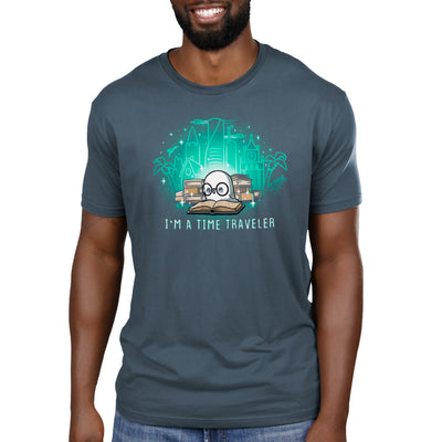 Premium Cotton T-shirt_Teeturtle denim blue I'm a Time Traveler apparel featuring a cute, glasses-wearing owl reading a book with a stack of books behind them with images of all the different time periods rising from those books and 'I'm a Time Traveler' written below.