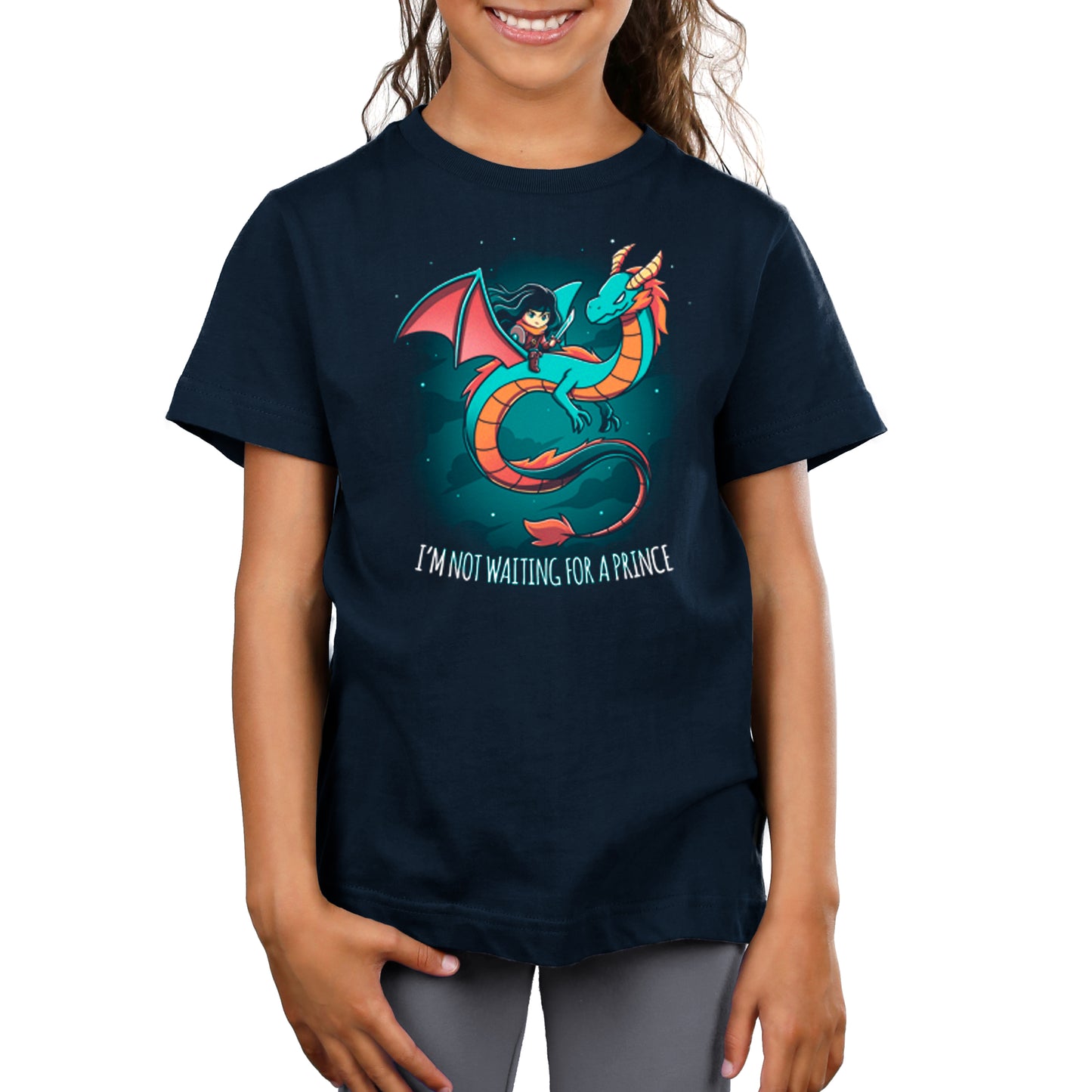 A child proudly wears a navy blue t-shirt featuring a fierce dragon design with the text "I'm not waiting for a prince." This stylish "I'm Not Waiting for a Prince" t-shirt by monsterdigital makes a bold statement.