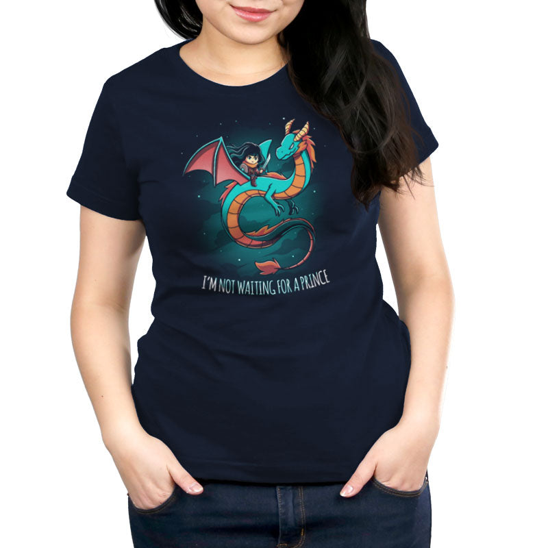 A person is seen wearing an "I'm Not Waiting for a Prince" t-shirt from monsterdigital, featuring a dynamic graphic of a girl riding a dragon. The navy blue t-shirt boldly states independence and adventure through its striking design.