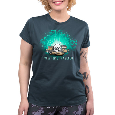 Premium Cotton T-shirt_Teeturtle denim blue I'm a Time Traveler apparel featuring a cute, glasses-wearing owl reading a book with a stack of books behind them with images of all the different time periods rising from those books and 'I'm a Time Traveler' written below.