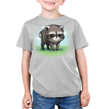 Premium Cotton T-shirt_TeeTurtle silver The Little Round Raccoon Premium Cotton T-shirt featuring a cute illustration of Jimothy, a raccoon with a short spine who gained internet fame for his unusual looks. He's smiling and you can see a little bit of the grass under him and the sky behind him. 