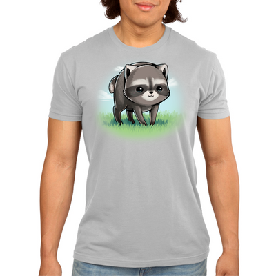 Premium Cotton T-shirt_TeeTurtle silver The Little Round Raccoon Premium Cotton T-shirt featuring a cute illustration of Jimothy, a raccoon with a short spine who gained internet fame for his unusual looks. He's smiling and you can see a little bit of the grass under him and the sky behind him. 