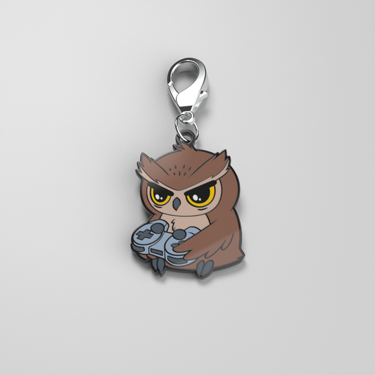 A TeeTurtle Night Owl Enamel Keychain showcases one's personal style while holding a controller.