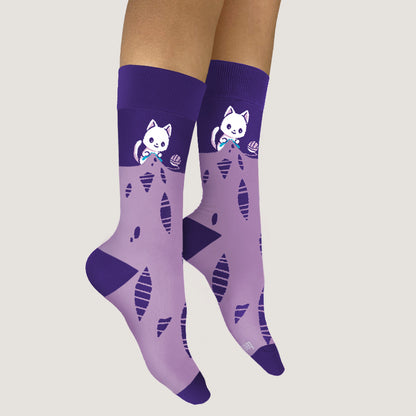 A pair of Knitting Cat Socks by TeeTurtle, with a cool cat on them, perfect fit for your feet.