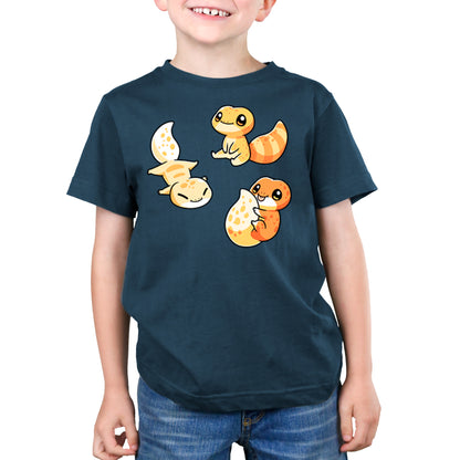 Child wearing a denim blue T-shirt with cartoon images of three orange and yellow Lil' Geckos in various poses, made from super soft ringspun cotton by monsterdigital.