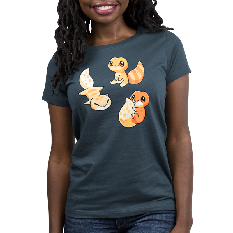 A denim blue t-shirt with a group of cute TeeTurtle Lil' Geckos on it.