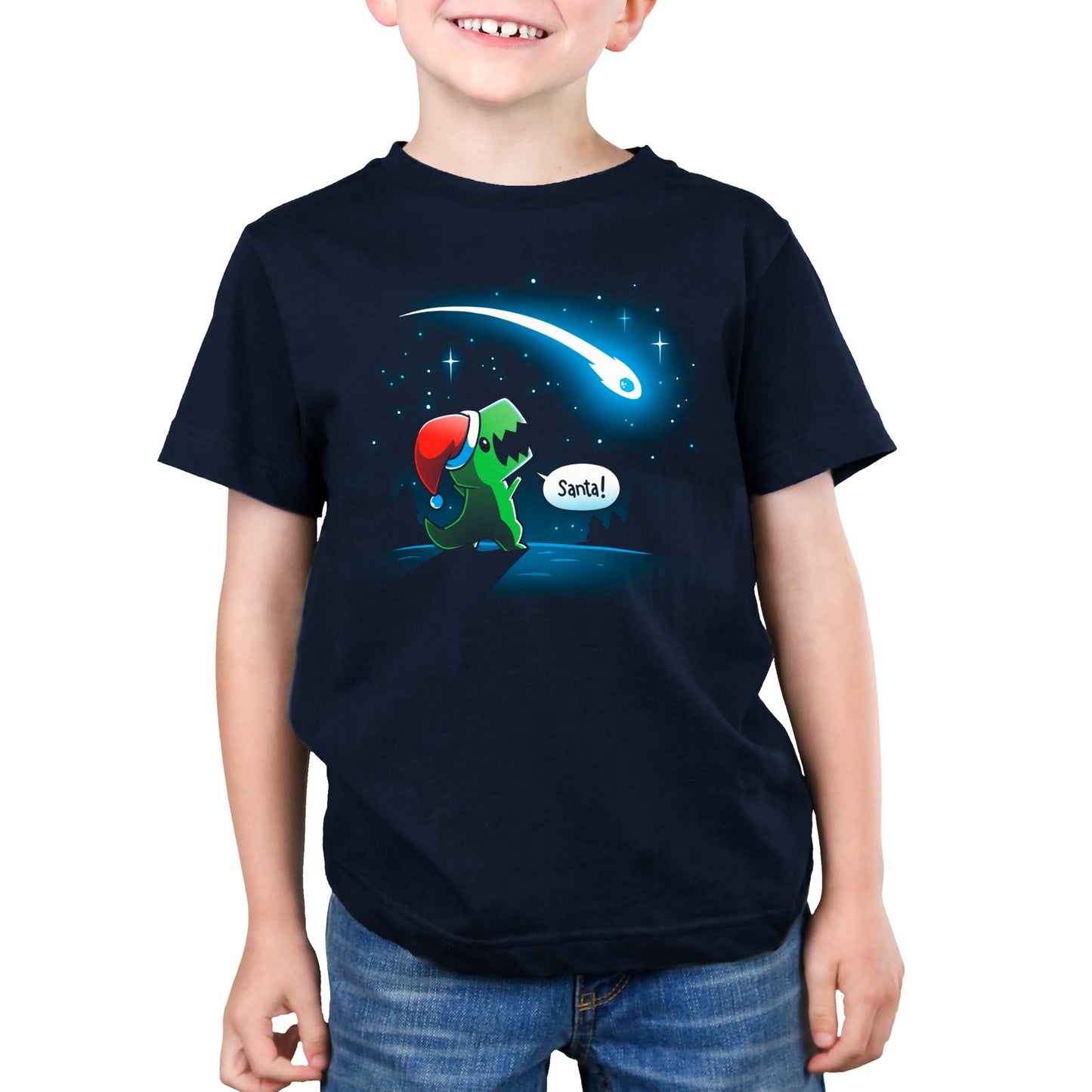 A boy wearing a navy blue TeeTurtle T-shirt with a dinosaur on it.