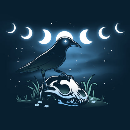 A mystical crow perched on a skull in the night sky, depicted on a TeeTurtle navy blue t-shirt.