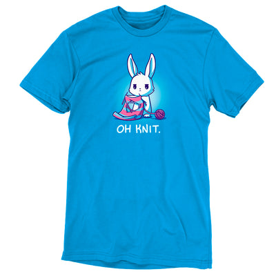 Premium Cotton T-shirt_Teeturtle cobalt blue Oh Knit apparel featuring a white rabbit looking distraught. It's holding two knitting needles attached to a blue and pink striped scarf that has a large hole in the middle. There is a ball of pink yarn trailing off to the side and text beneath it that says "Oh knit."