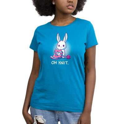 Premium Cotton T-shirt_Teeturtle cobalt blue Oh Knit apparel featuring a white rabbit looking distraught. It's holding two knitting needles attached to a blue and pink striped scarf that has a large hole in the middle. There is a ball of pink yarn trailing off to the side and text beneath it that says "Oh knit."