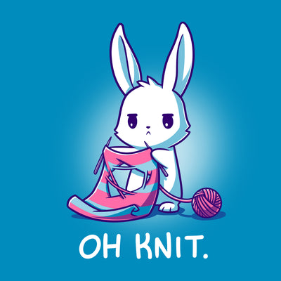 Premium Cotton T-shirt_Teeturtle cobalt blue Oh Knit apparel featuring a white rabbit looking distraught. It's holding two knitting needles attached to a blue and pink striped scarf that has a large hole in the middle. There is a ball of pink yarn trailing off to the side and text beneath it that says "Oh knit."