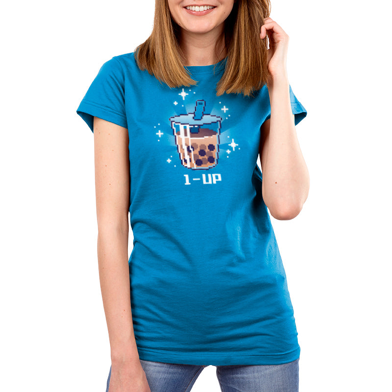 A woman wearing a blue 1-Up Boba T-shirt holding a cup of tea. (Brand Name: TeeTurtle)