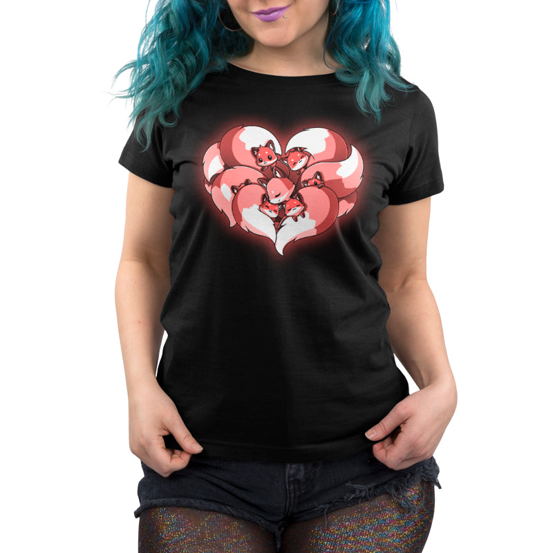 A woman wearing a TeeTurtle "A Mother's Love" black t-shirt with a heart on it.