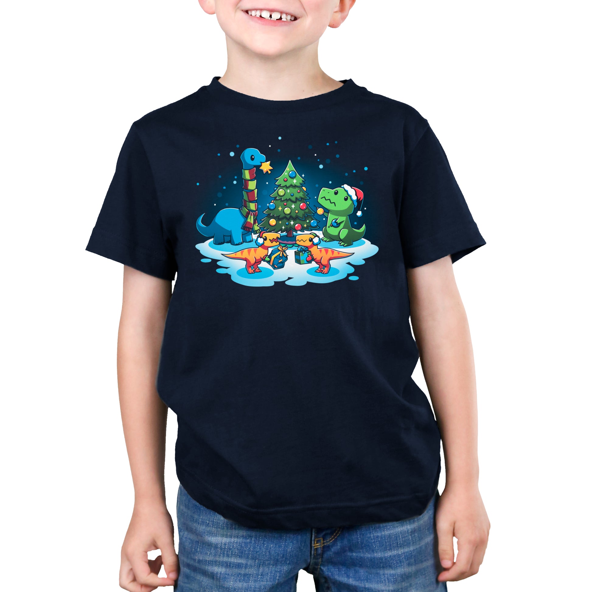 A boy wearing a "A Very Dino Christmas" t-shirt by TeeTurtle, receiving a gift.