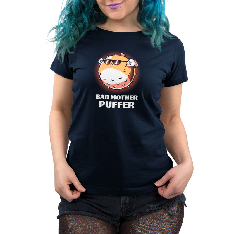 A woman wearing a navy blue t-shirt that says TeeTurtle Bad Mother Puffer.