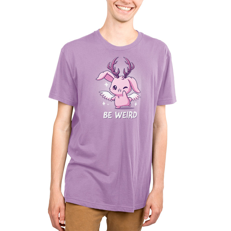A young man in a lavender t-shirt that says "Be Weird" from TeeTurtle.