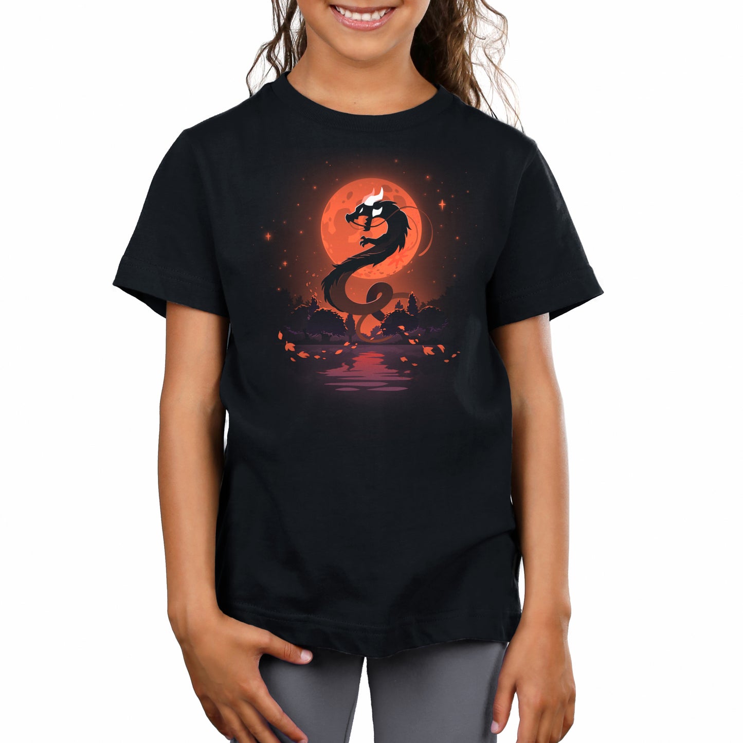 A girl wearing a black t-shirt with an image of Blood Moon Dragon on it from TeeTurtle.
