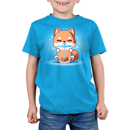 A boy wearing a TeeTurtle Boba Shiba t-shirt.