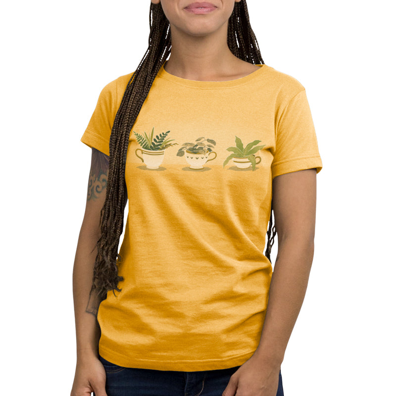 A woman with braided hair wearing a Botanical Brews cotton yellow T-shirt from TeeTurtle.
