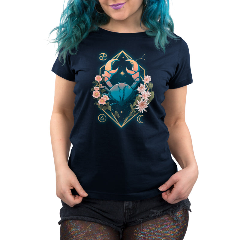 A woman wearing a Cancer Zodiac navy blue t-shirt with a flower on it by TeeTurtle.