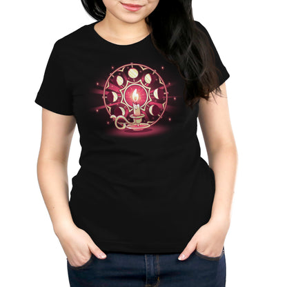 A person wearing a black t-shirt made by monsterdigital called Candlelit Orbit, made from Super Soft Ringspun Cotton with a design featuring a lit candle surrounded by a circular pattern representing the lunar cycle with nine moons in various phases.