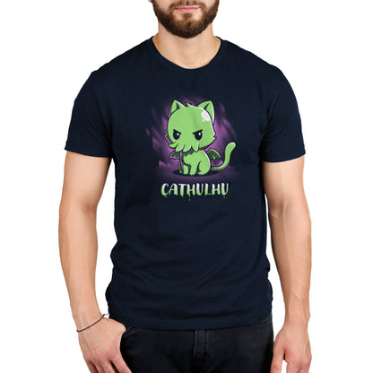 A man wearing a Cathulhu t-shirt from TeeTurtle with a cat toy on it.