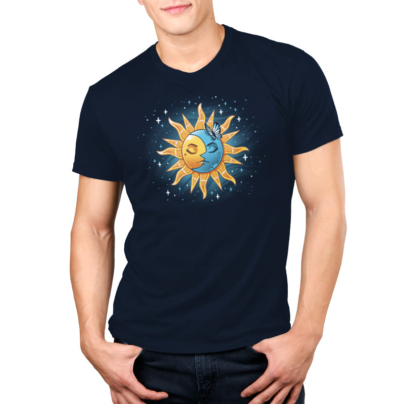 A man wearing a navy blue Celestial Duo T-shirt from TeeTurtle with the sun and moon design.
