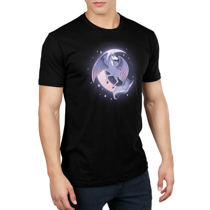 A man displaying grace while wearing a black Celestial Winged Unicorn T-shirt from TeeTurtle with a beautiful image of a cat on the moon.