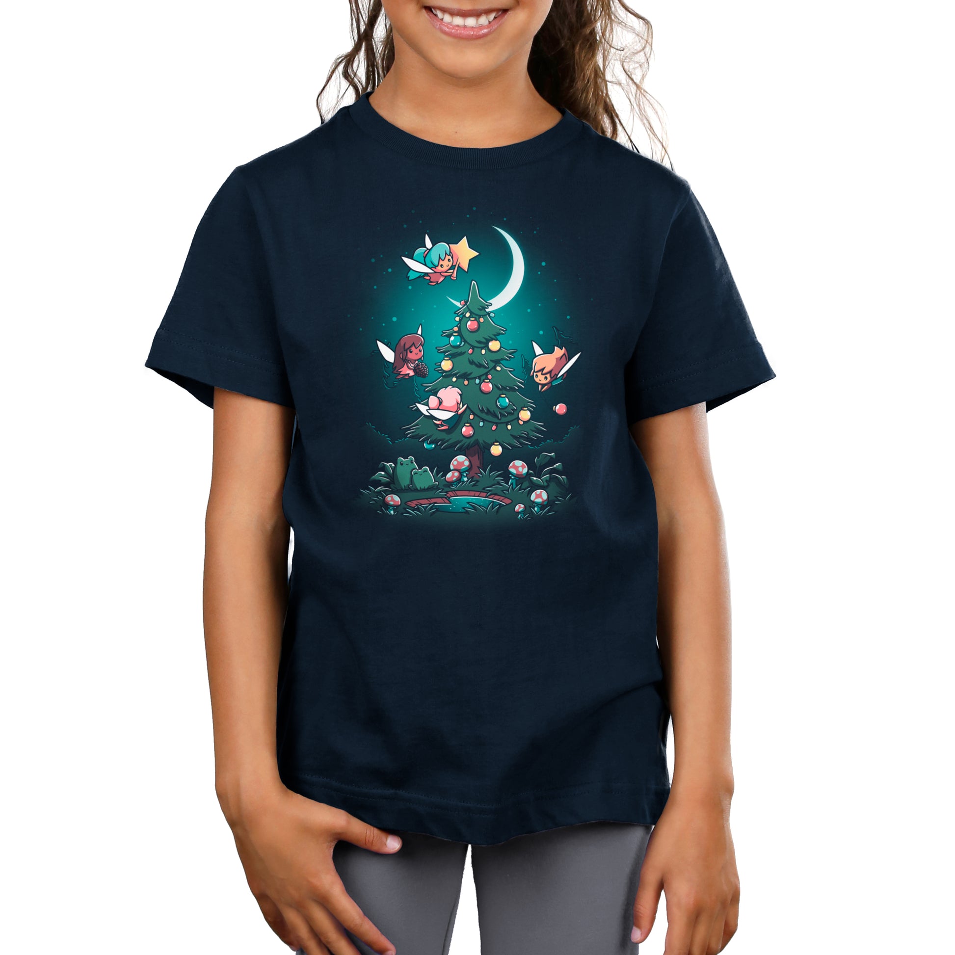 A girl wearing a TeeTurtle navy blue t-shirt with an image of Christmas Fairies.