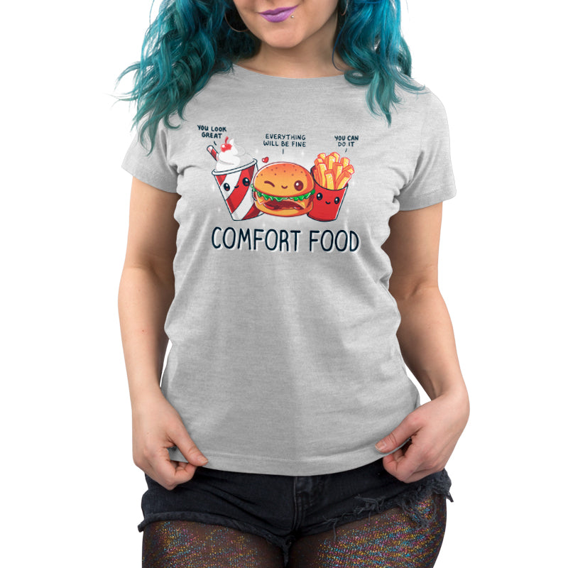 Premium Cotton T-shirt - Person wearing a gray monsterdigital Comfort Food unisex apparelmade of super soft ringspun cotton, adorned with illustrations of a drink, a burger, and fries with positive messages, and the text "COMFORT FOOD" below them. The person has blue hair and black shorts.