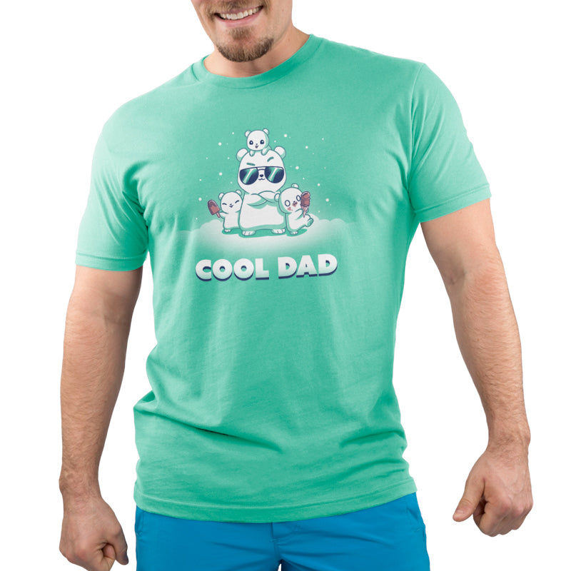 A man wearing a green t-shirt with the brand name "TeeTurtle" and the product name "Cool Dad" printed on it.