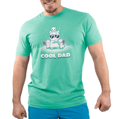 A man wearing a green t-shirt with the brand name "TeeTurtle" and the product name "Cool Dad" printed on it.