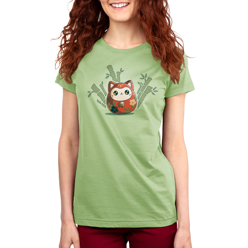 A woman wearing a Daruma Kitty ringspun cotton T-shirt by TeeTurtle with a cartoon owl on it.