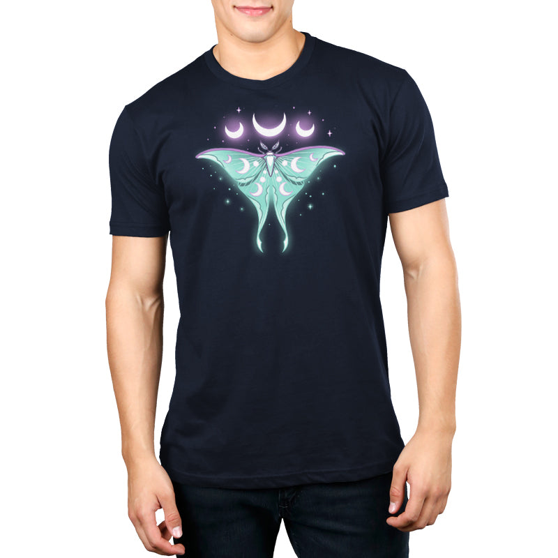 A man wearing an Ethereal Moth t-shirt by TeeTurtle with a moon and stars on it.
