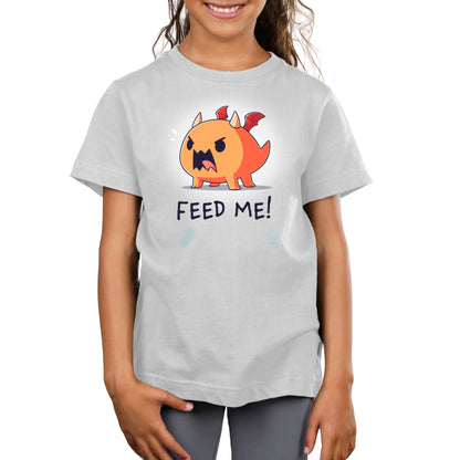 A girl wearing an Unstable Games "Feed Me! (Dragon)" t-shirt.