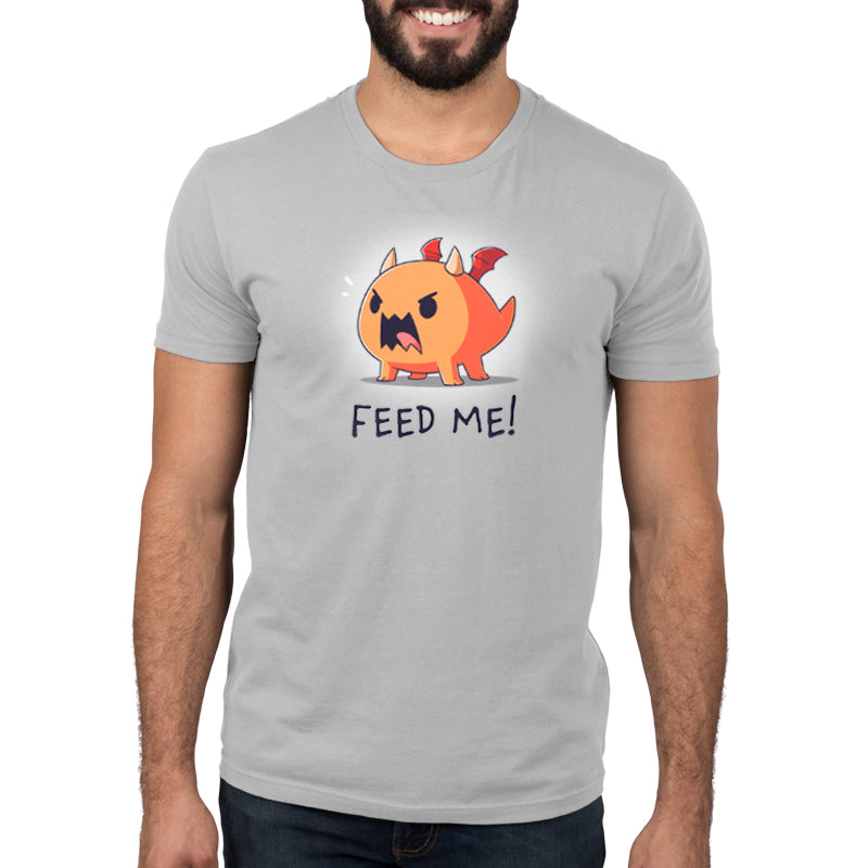 A man wearing an Unstable Games TeeTurtle original t-shirt that says "Feed Me! (Dragon).