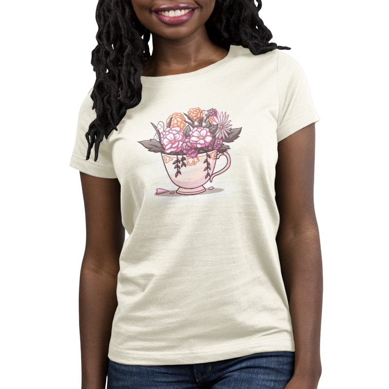 A woman wearing a TeeTurtle Floral Tea t-shirt with an image of a cup and flowers.