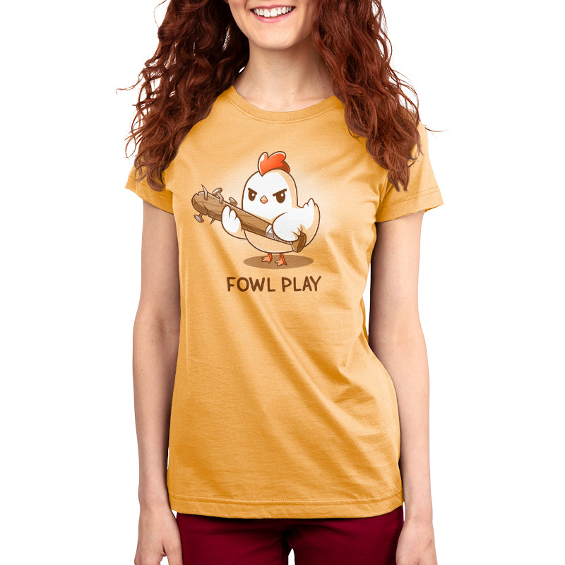 A woman wearing a yellow Fowl Play t-shirt with a chicken design by TeeTurtle.