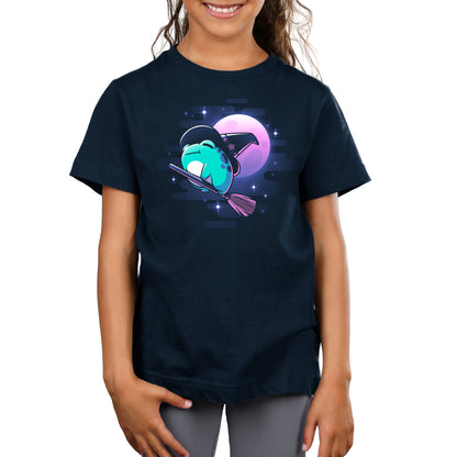 A TeeTurtle girl wearing a navy blue t-shirt with an image of a TeeTurtle Frog Witch flying on a broom.