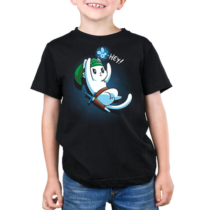 A child wearing a Hey! T-shirt by monsterdigital made from super soft ringspun cotton, featuring an illustration of a cartoon character dressed in a green hat and wielding a sword, accompanied by the word "Hey!" in a speech bubble. This unisex tee provides both comfort and style.