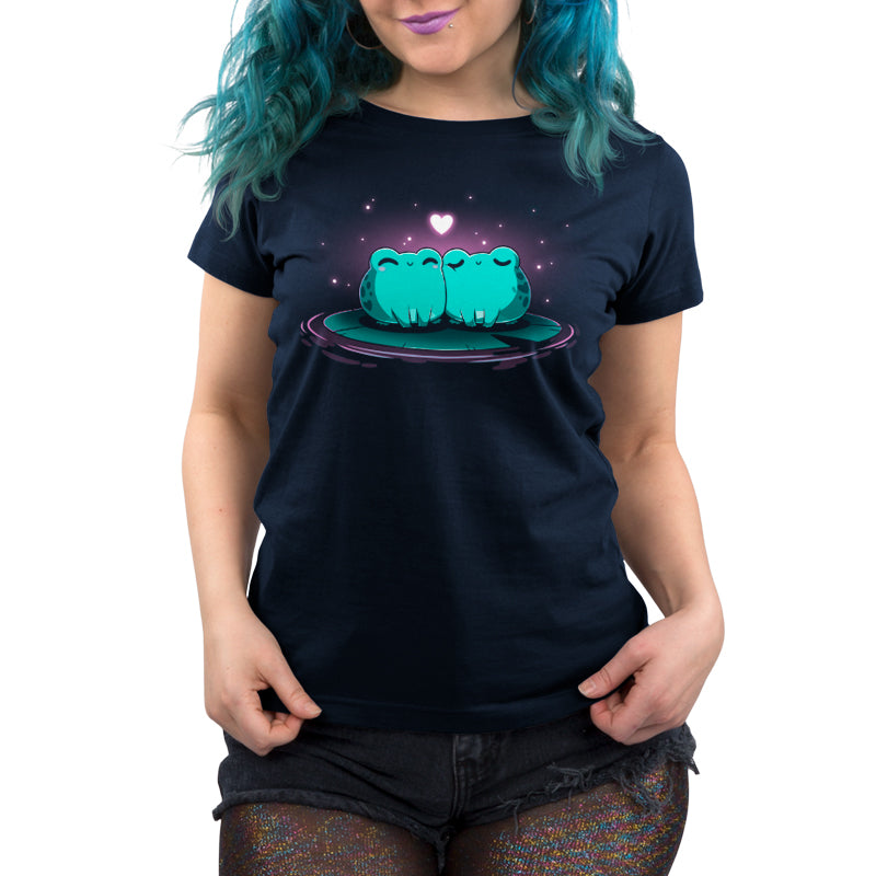 A woman wearing a navy blue Hoppy Together t-shirt with two frogs on it from TeeTurtle.