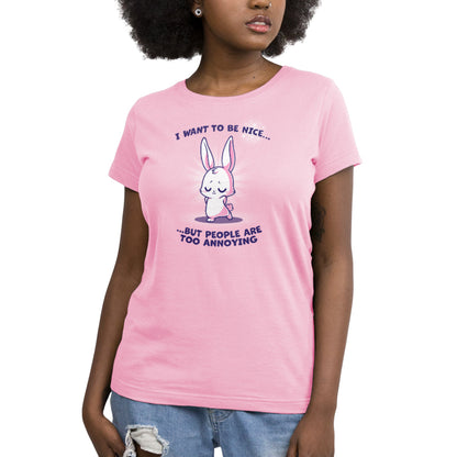 A woman wearing an "I Want to Be Nice..." pink t-shirt from TeeTurtle.