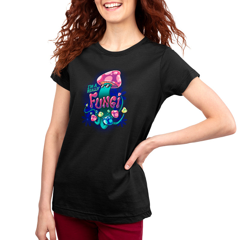 A woman wearing a comfortable black "I'm a Really Fungi" t-shirt by TeeTurtle with a flower on it.