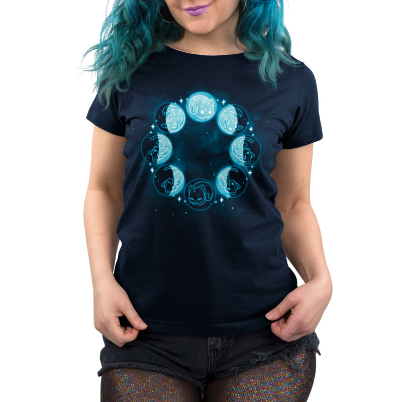 A woman with blue hair wearing a navy blue Kitty Moon Phases t-shirt by TeeTurtle.